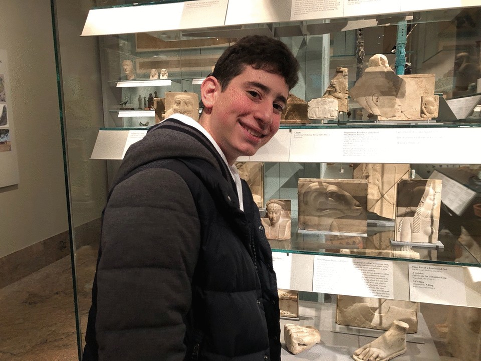 Ninth grade student proudly displaying the Ram god Amun-Re in the Metropolitan Museum of Art