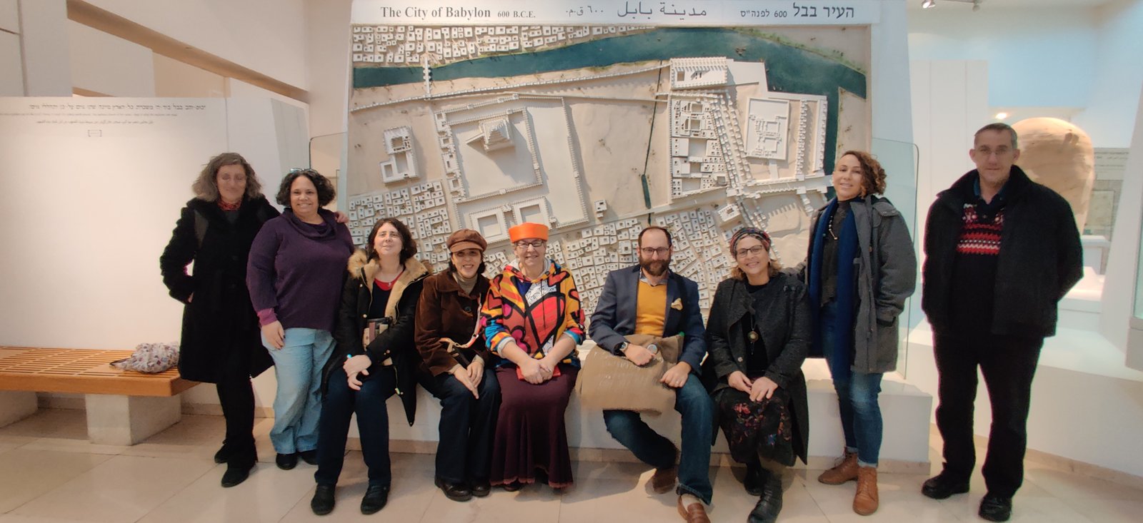 Tour group examining the Babylon model at the museum