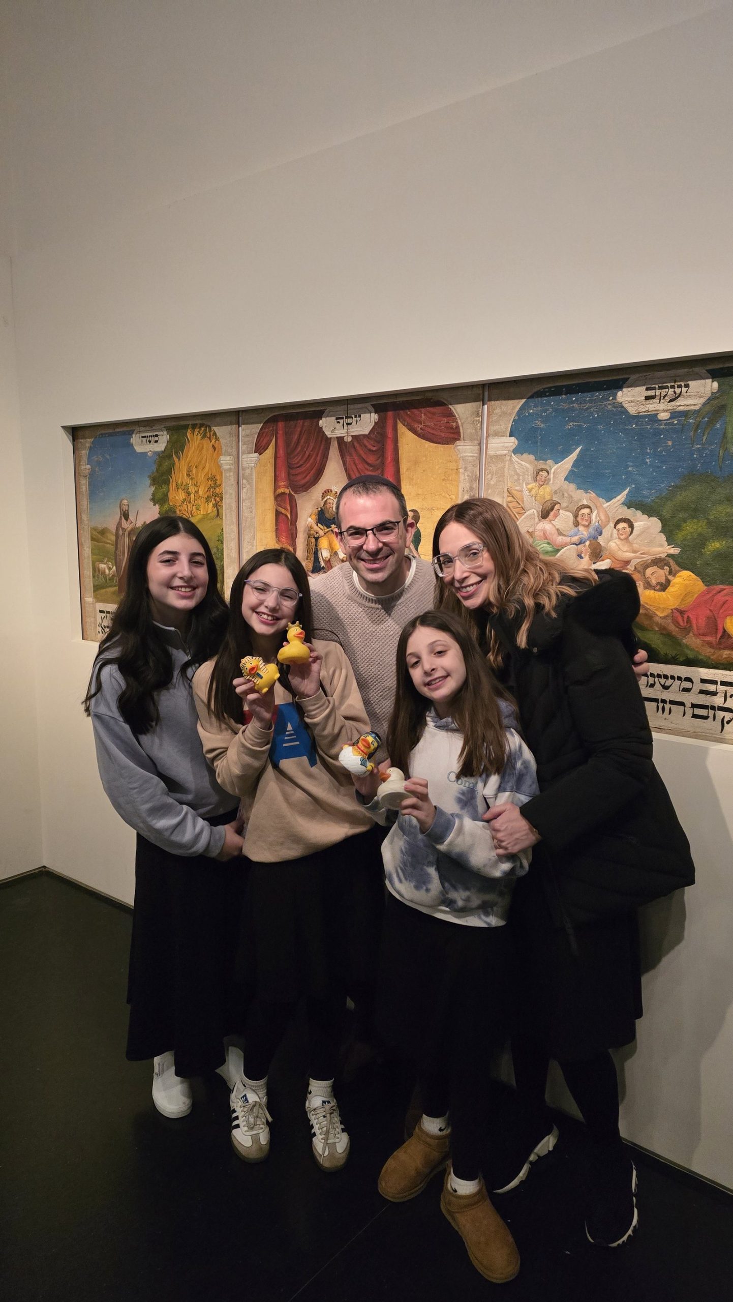 Family public tour group at the Israel Museum holding sTOURytelling rubber ducks