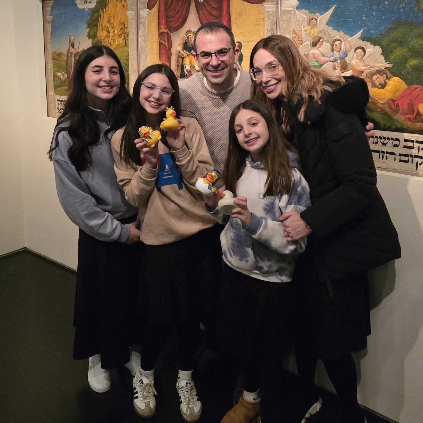 Family public tour group at the Israel Museum holding sTOURytelling rubber ducks